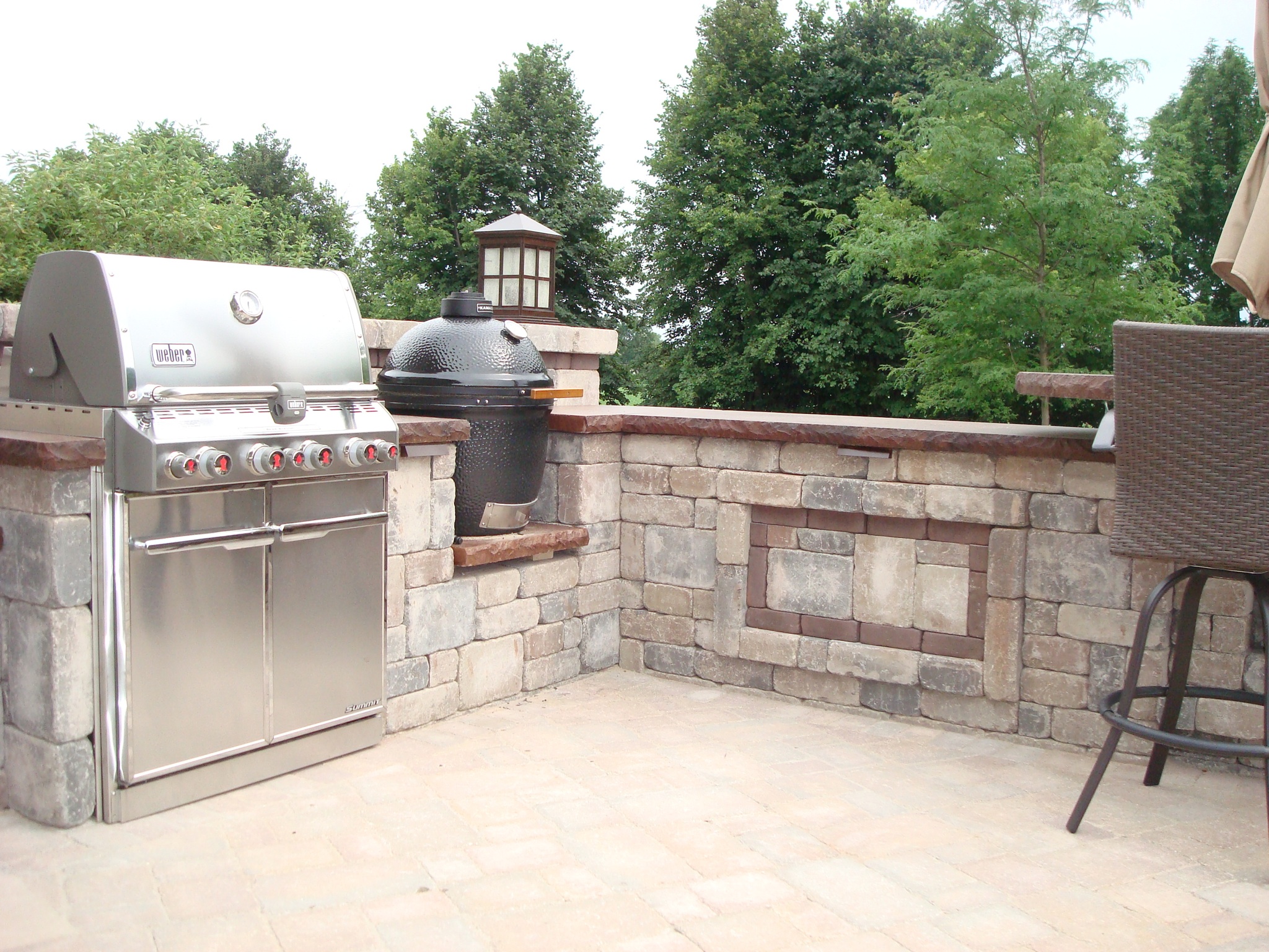 large grill with smoker in retaining wall on patio