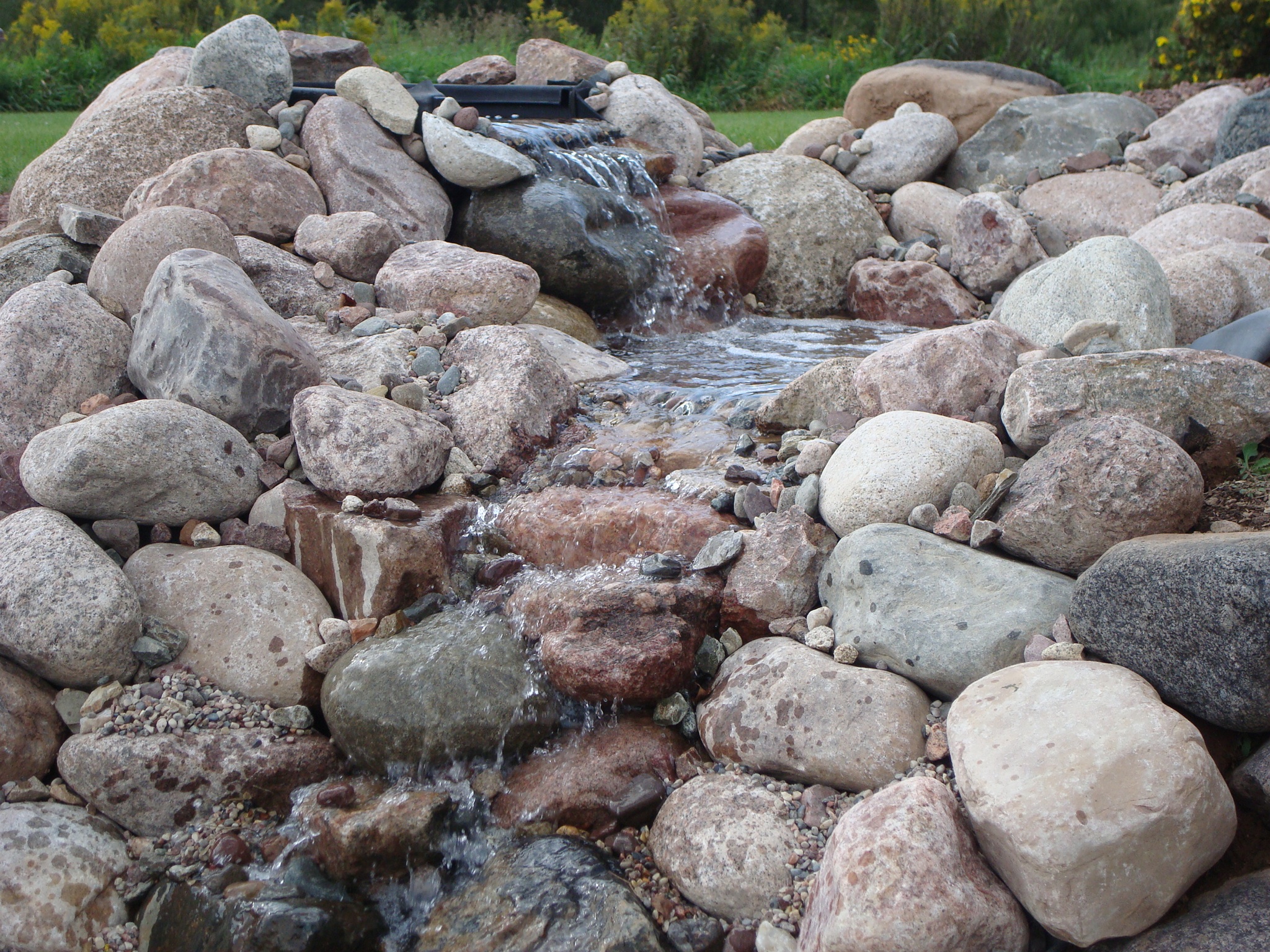 cascading water feature along rocks with 2 stop levels 