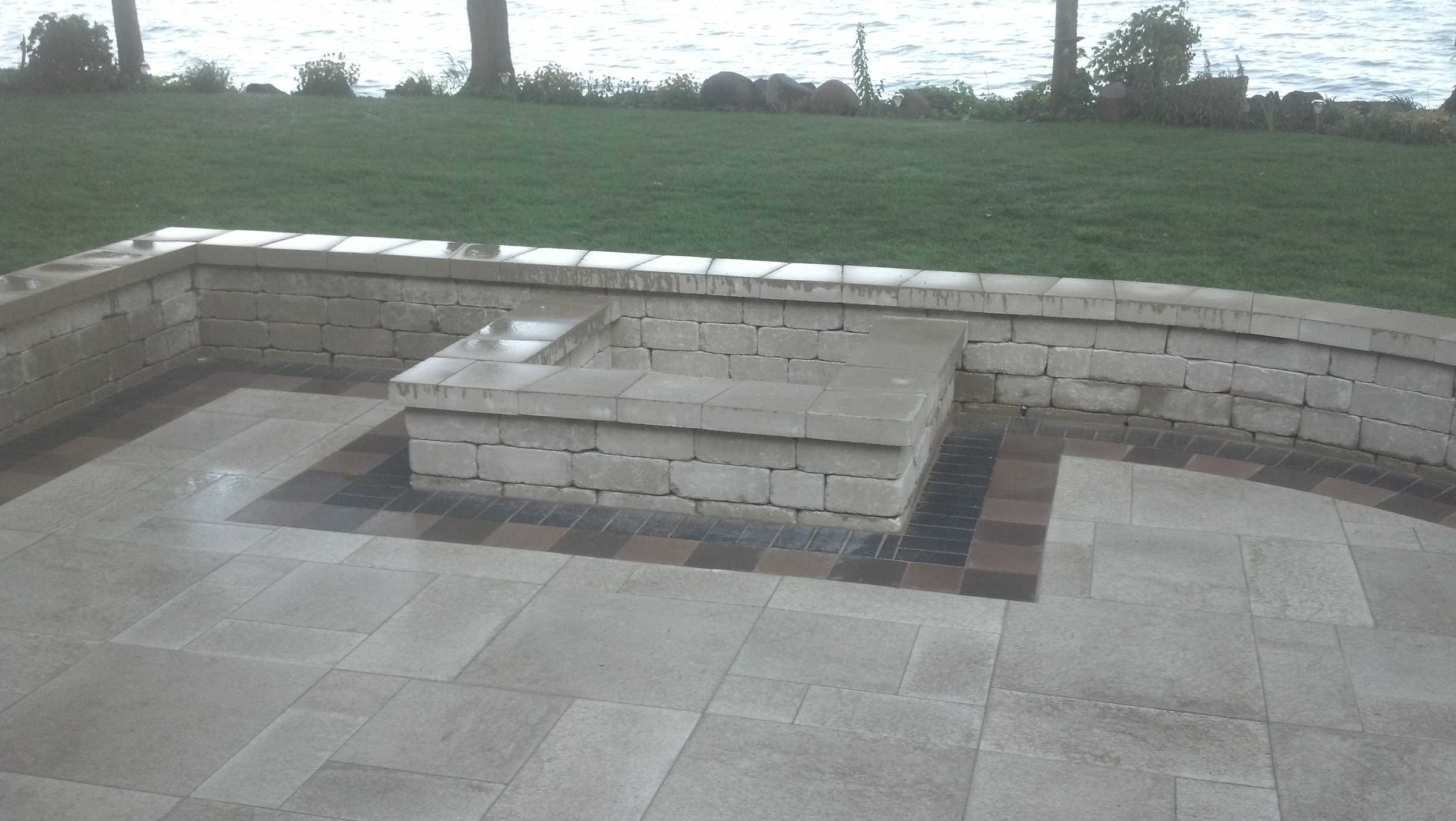 rectangular above-ground fire pit along patio sit wall
