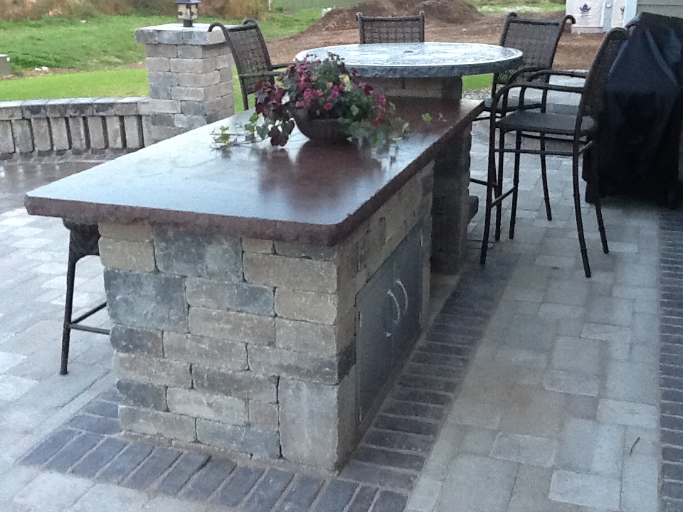 small outdoor bar next to patio seating