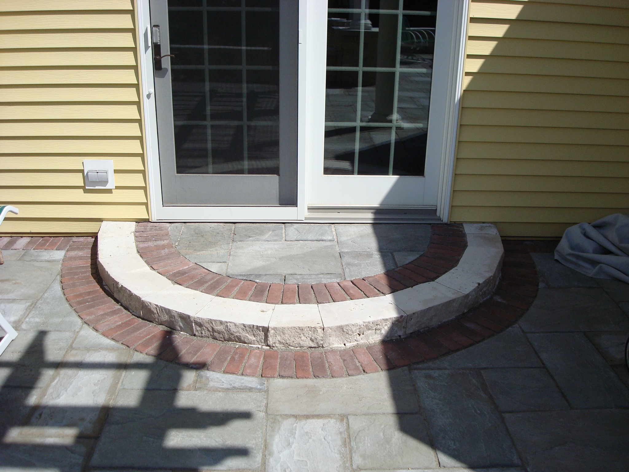 short half-circle step leading to patio French door