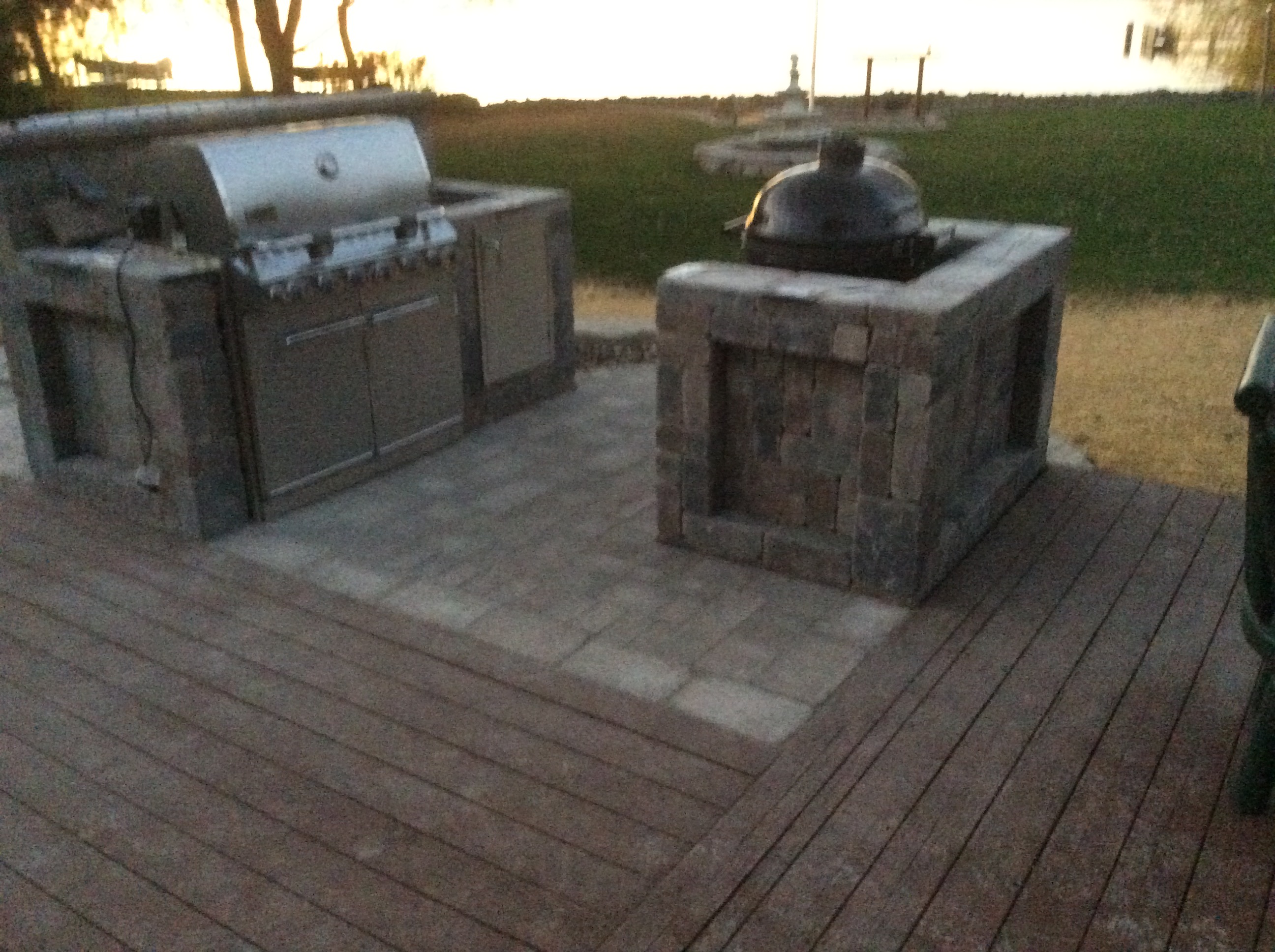 grill and smoker in outdoor kitchen patio area at sundown 