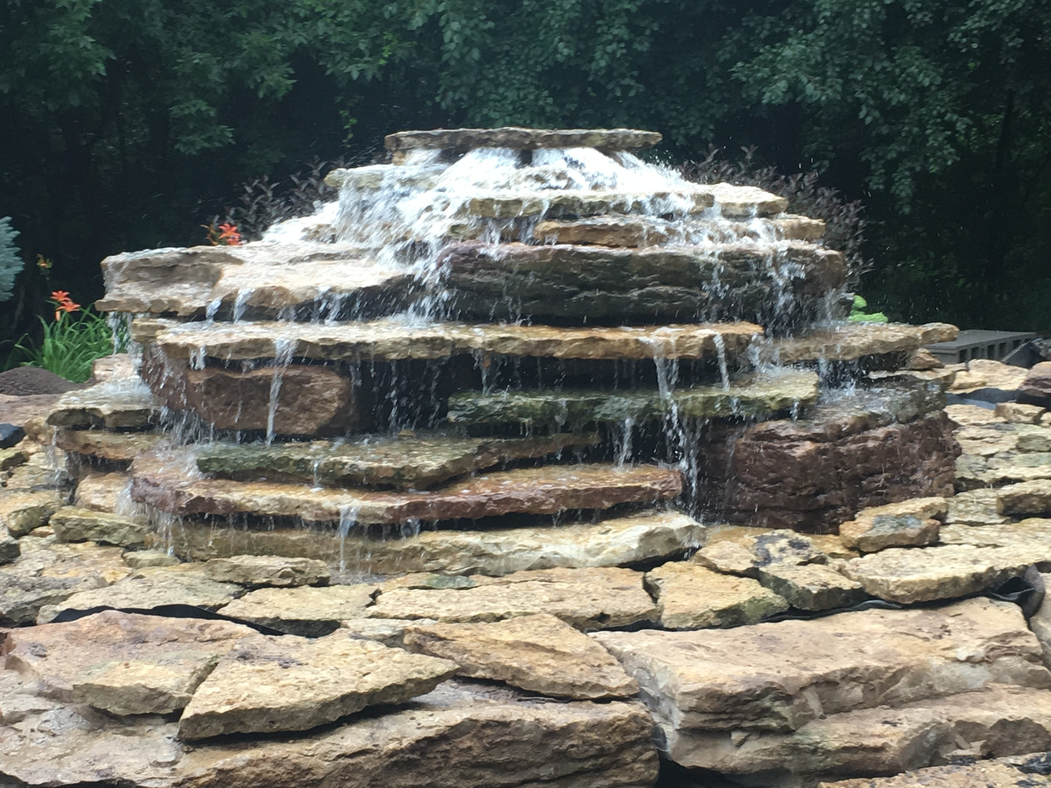bubbling water feature that cascades down stacked stones