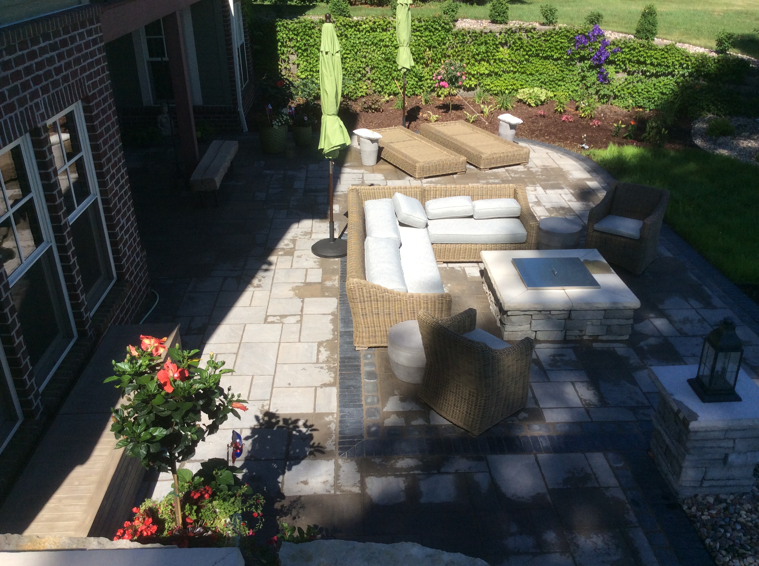 rectangle fire pit in lower patio area with stone bench seating